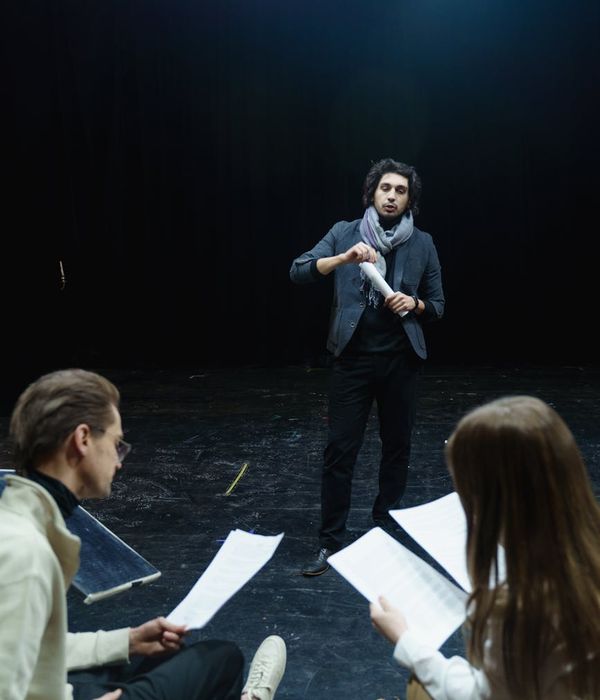 Man performing a controlled strength exercise in a dark room with emerald light.